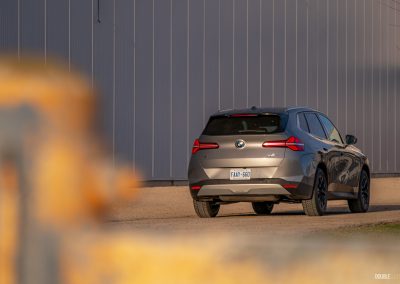 Rear three quarter view of the 2025 BMW X3 30 at sunset