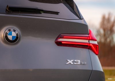 2025 BMW X3 30 close up view of tail light and model badge