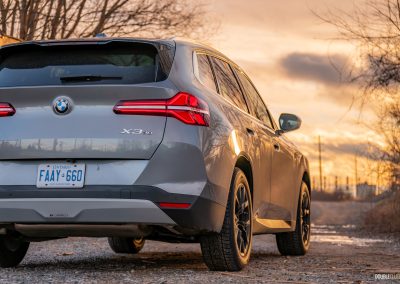 Rear three quarter view of the 2025 BMW X3 30 at sunset