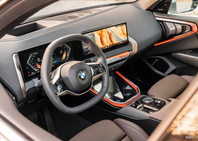 2025 BMW X3 30 interior view of dashboard and steering wheel from driver's window