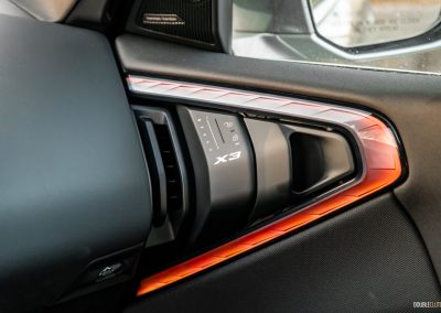 2025 BMW X3 30 interior detail view door handle and vent with X3 branding