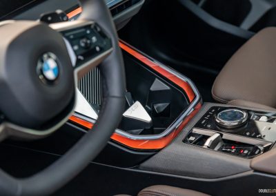 2025 BMW X3 30 interior detail view of center console and steering