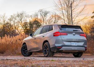 Rear three quarter view of the 2025 BMW X3 30 at sunset