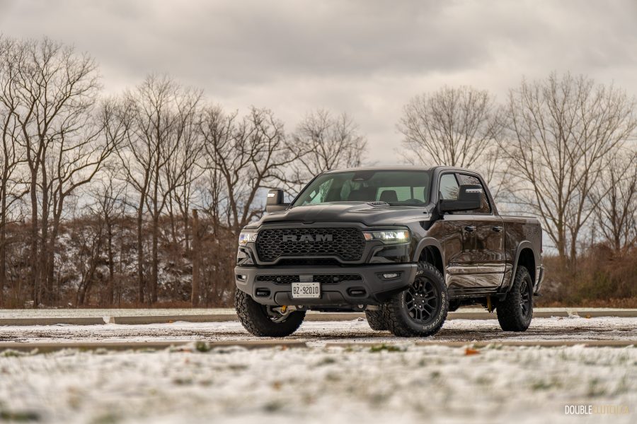 Black 2025 Ram 1500 Rebel front three quarter view outdoors