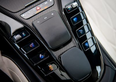 2025 Mercedes-AMG GT 63 S E-Performance 4-Door Coupe close up detail of carbon fiber trim and center console controls