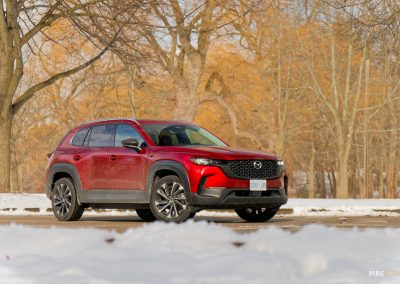 Front quarter view of a 2025 Mazda CX-50 Hybrid in the snow