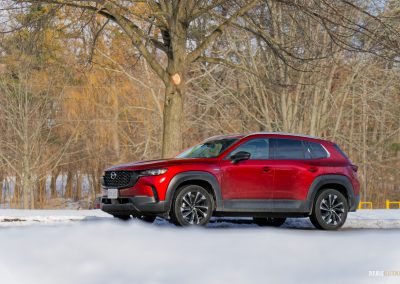 Front quarter view of a 2025 Mazda CX-50 Hybrid in the snow