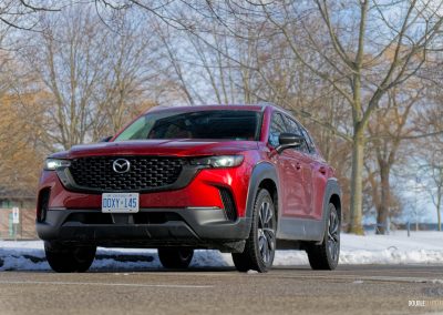 Front quarter view of a 2025 Mazda CX-50 Hybrid in the snow