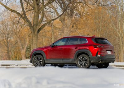 Rear quarter view of a 2025 Mazda CX-50 Hybrid in the snow