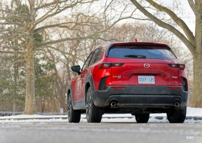 Rear quarter view of a 2025 Mazda CX-50 Hybrid in the snow