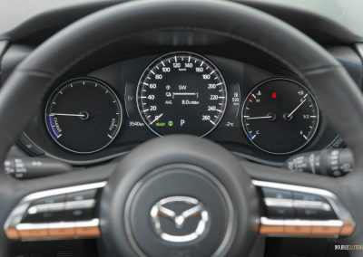 Close-up of the partially digital gauge cluster in a 2025 Mazda CX-50 Hybrid