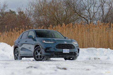 Front quarter view of the 2025 Honda HR-V parked in a snowy field with trees in the background