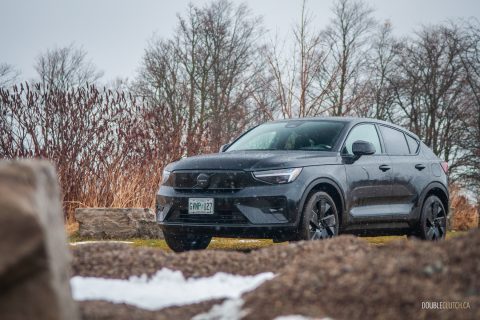 Front quarter view of the 2025 Volvo EC40 on a cloudy day, with trees in the background