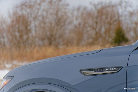 Close-up of the stylized front fender logo on a grey 2025 Mazda CX-70 GT PHEV