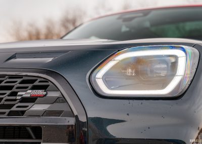 Close-up view of the headlight and front grille design on the 2025 Mini Countryman JCW