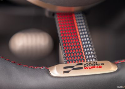 Close-up showing the fabric steering wheel spoke and gold accents in the 2025 Mini Countryman JCW