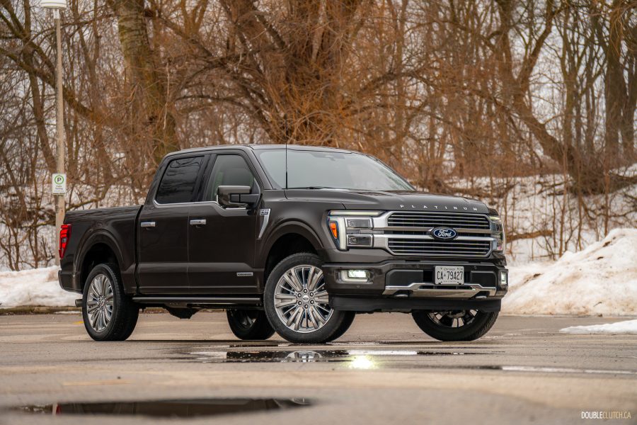 Front quarter view of a 2025 Ford F-150 Platinum Powerboost with trees in the background