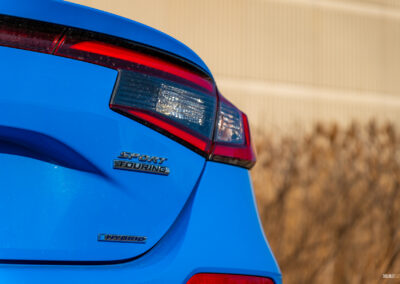 Close-up view showing the rear badges and tail light design on a 2025 Honda Civic Hybrid Hatchback