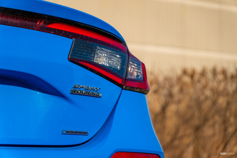 Close-up view showing the rear badges and tail light design on a 2025 Honda Civic Hybrid Hatchback