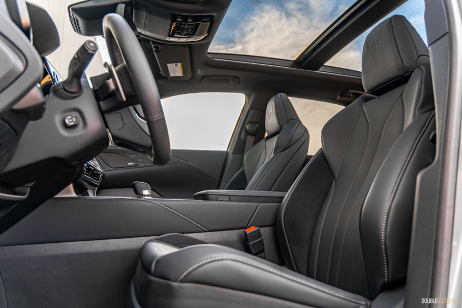 Interior view of the front seats and panoramic sunroof in a 2025 Lexus RX 500h Black Line Special Edition