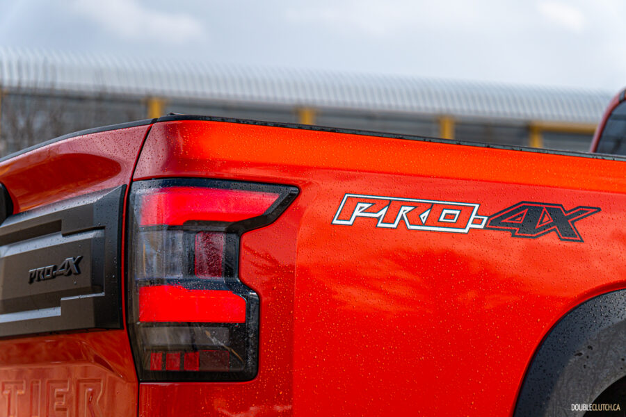 Close-up showing the tail lights and bed graphics on a 2025 Nissan Frontier PRO-4X Luxury