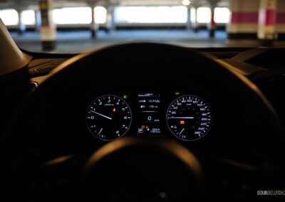 Interior view showing the gauge cluser of a 2025 Subaru Ascent in a dark environment
