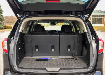 Interior view showing the cargo area with the seats up and a snow brush for scale in a 2025 Subaru Ascent