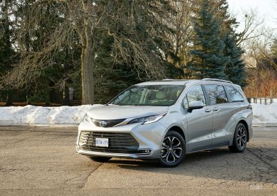 Front quarter view of a 2025 Toyota Sienna against a backdrop of trees