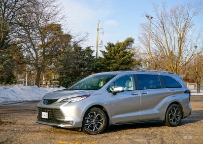 Front quarter view of a 2025 Toyota Sienna against a backdrop of trees