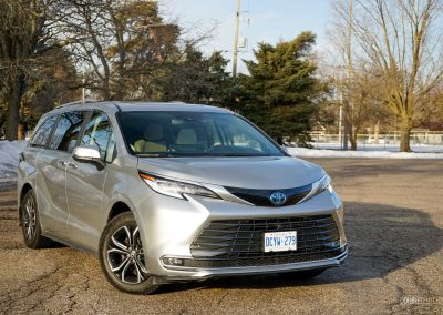 Front quarter view of a 2025 Toyota Sienna against a backdrop of trees