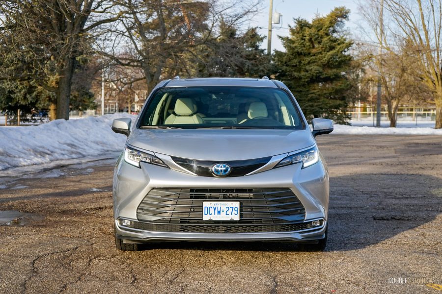 Front view of a 2025 Toyota Sienna against a backdrop of trees