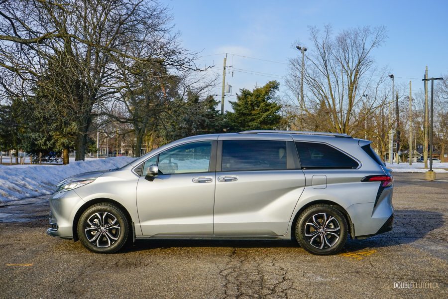 Side profile view of a 2025 Toyota Sienna against a backdrop of trees