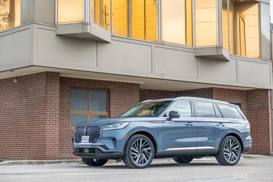 Front quarter view of the 2025 Lincoln Aviator Reserve with a building in the background