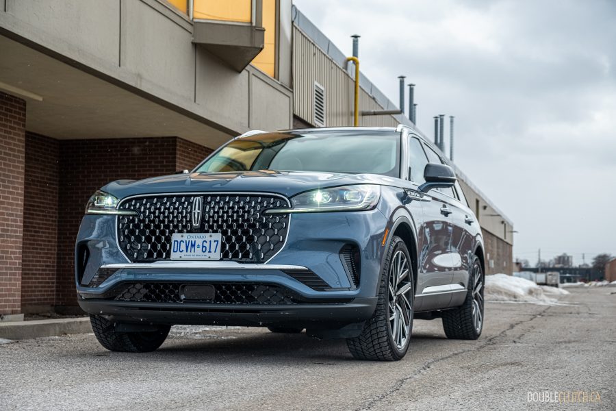 Front quarter view of the 2025 Lincoln Aviator Reserve with a building in the background