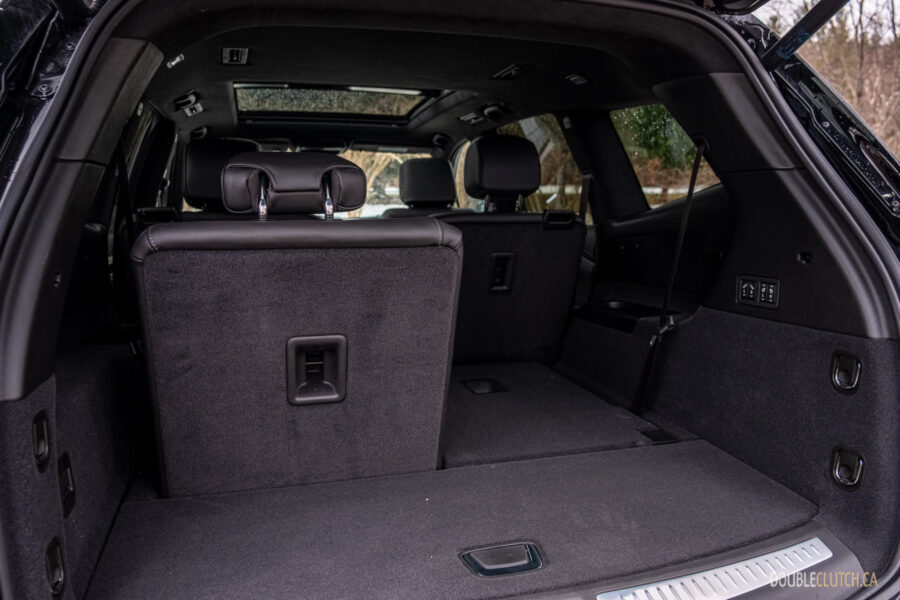 Interior view of the cargo area in a 2025 Cadillac XT6 with the third row partially folded
