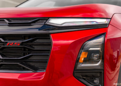 Close-up view of the redesigned front fascia on a red 2025 Chevrolet Equinox