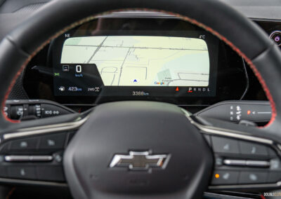 Interior close-up showing the digital gauge cluster and steering wheel in a 2025 Chevrolet Equinox