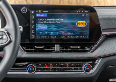 Interior view showing the infotainment display and physical climate control switchgear in a 2025 Chevrolet Equinox