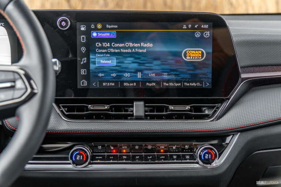 Interior view showing the infotainment display and physical climate control switchgear in a 2025 Chevrolet Equinox