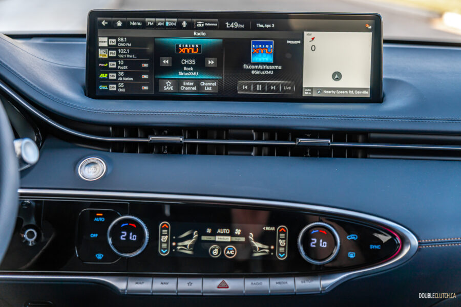 Close-up of the infotainment display and climate controls in a 2025 Genesis GV70 3.5T Sport Plus