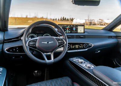 Interior view showing the dashboard design and layout in a 2025 Genesis GV70 3.5T Sport Plus