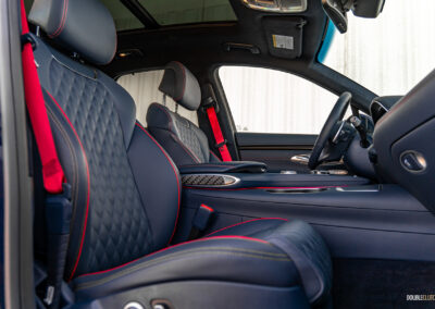 Interior view showing the front-seat area in a 2025 Genesis GV70 3.5T Sport Plus