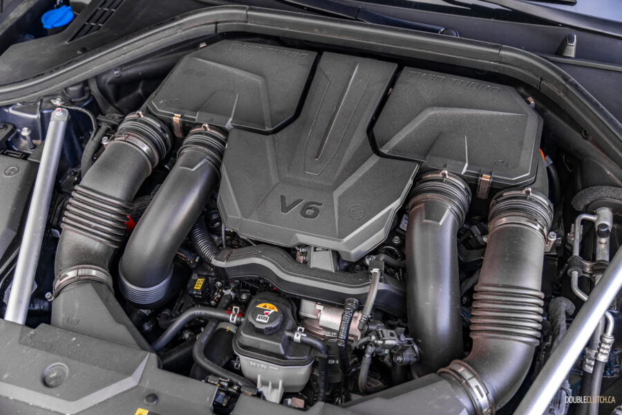 Under-hood view showing the twin-turbocharged V6 in a 2025 Genesis GV70 3.5T Sport Plus