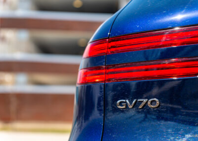 Close-up showing the tail lights and rear badges on a 2025 Genesis GV70 3.5T Sport Plus
