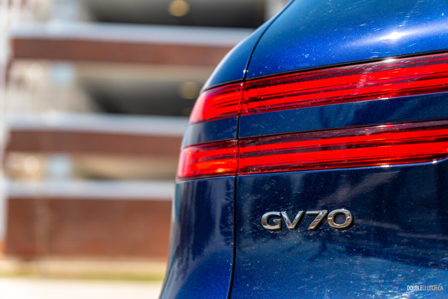 Close-up showing the tail lights and rear badges on a 2025 Genesis GV70 3.5T Sport Plus