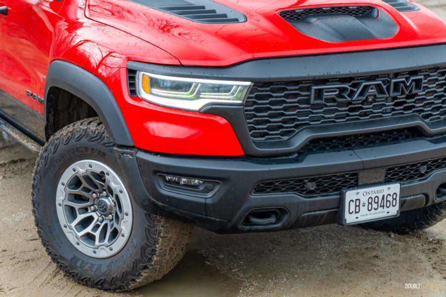 Cropped front quarter view of a red 2025 Ram 1500 RHO, showing the restyled front fascia and wheels