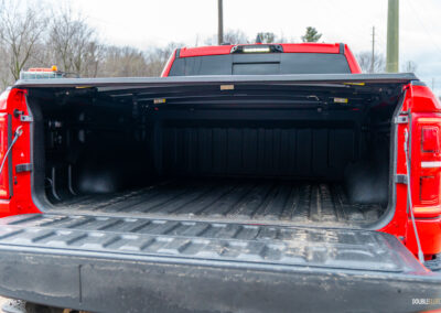 The bed of a 2025 Ram 1500 RHO with the tailgate ajar