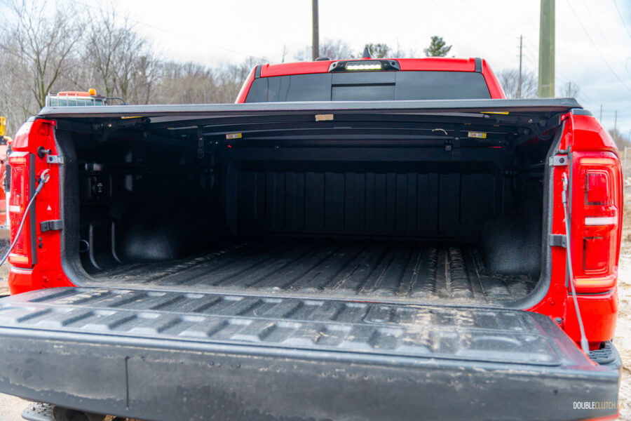 The bed of a 2025 Ram 1500 RHO with the tailgate ajar