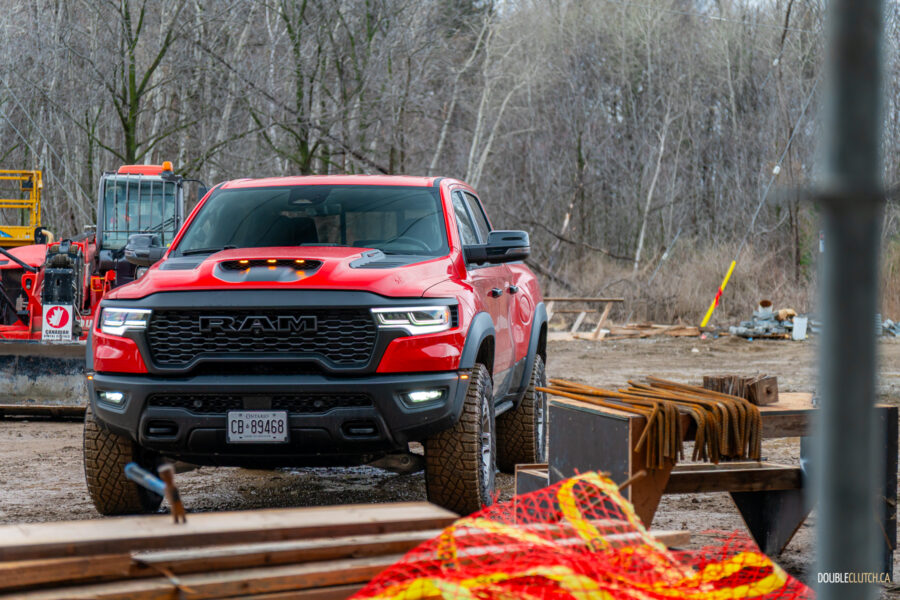 Front quarter view of a red 2025 Ram 1500 RHO, parked in a muddy construction site