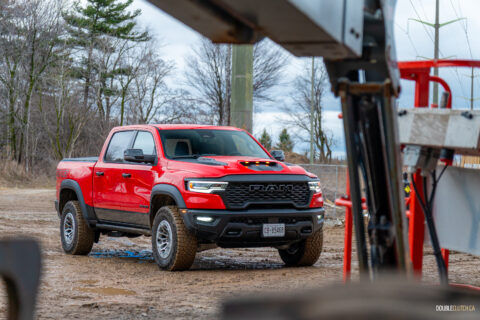 Front quarter view of a red 2025 Ram 1500 RHO, parked in a muddy construction site